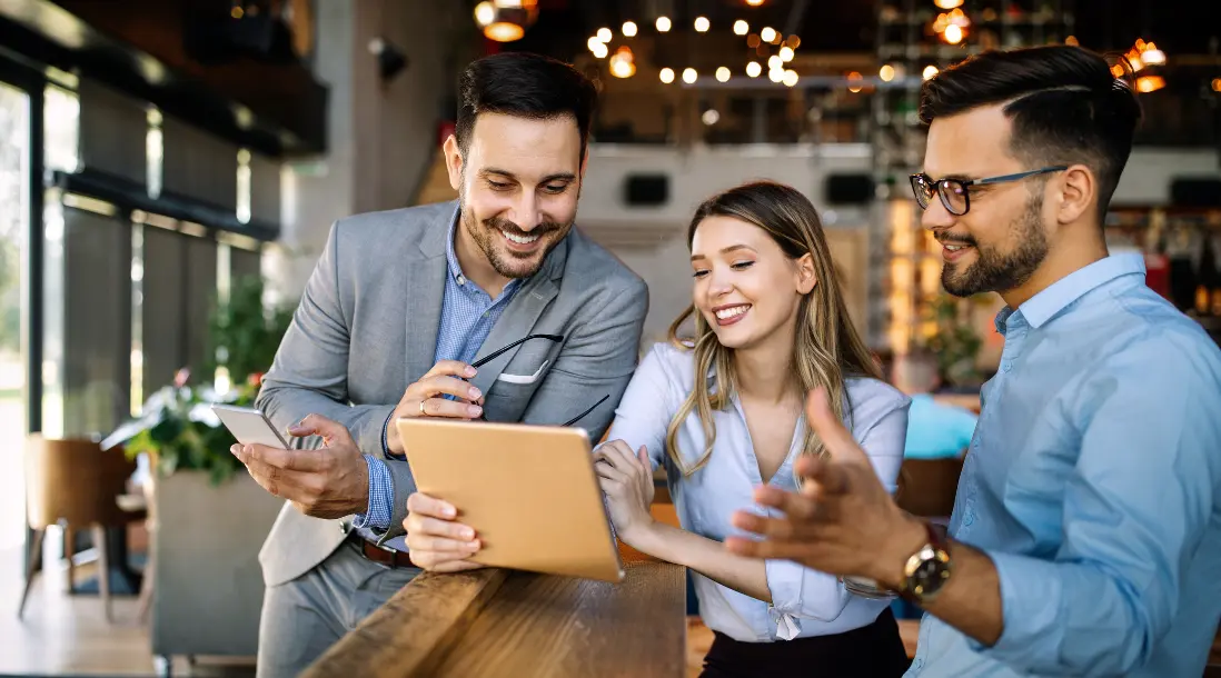 Team collaborating with an accounting firm workflow software on a tablet to streamline financial processes, communication, and client management