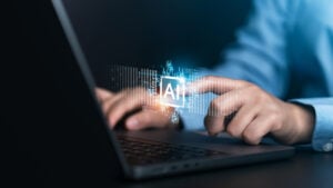 someone on laptop touching AI floating button