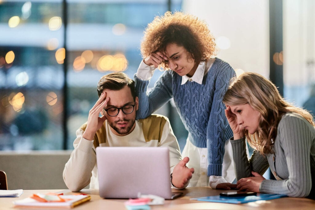 Overworked accounting team switching between multiple screens
