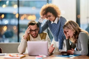 Overworked accounting team switching between multiple screens