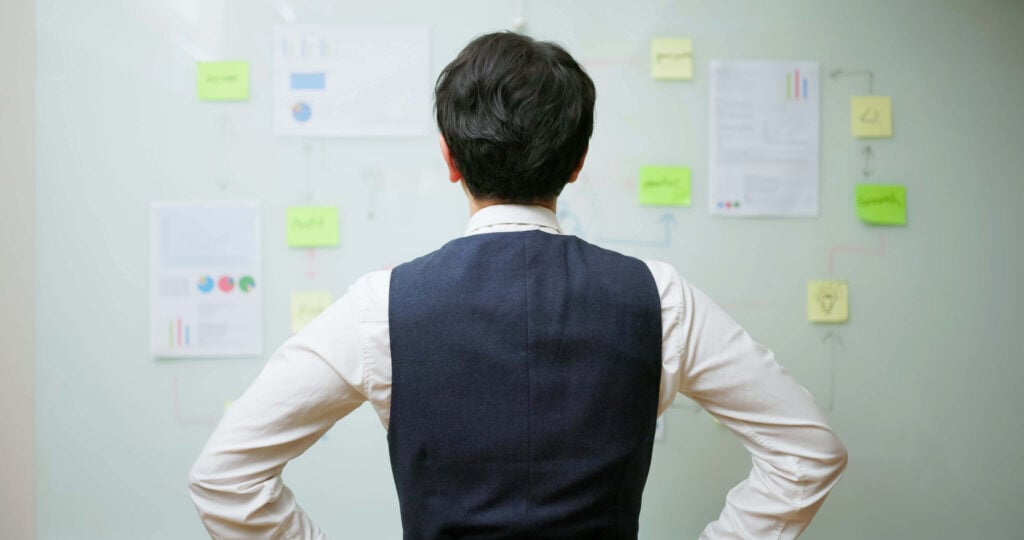 professional looking at board with workflow