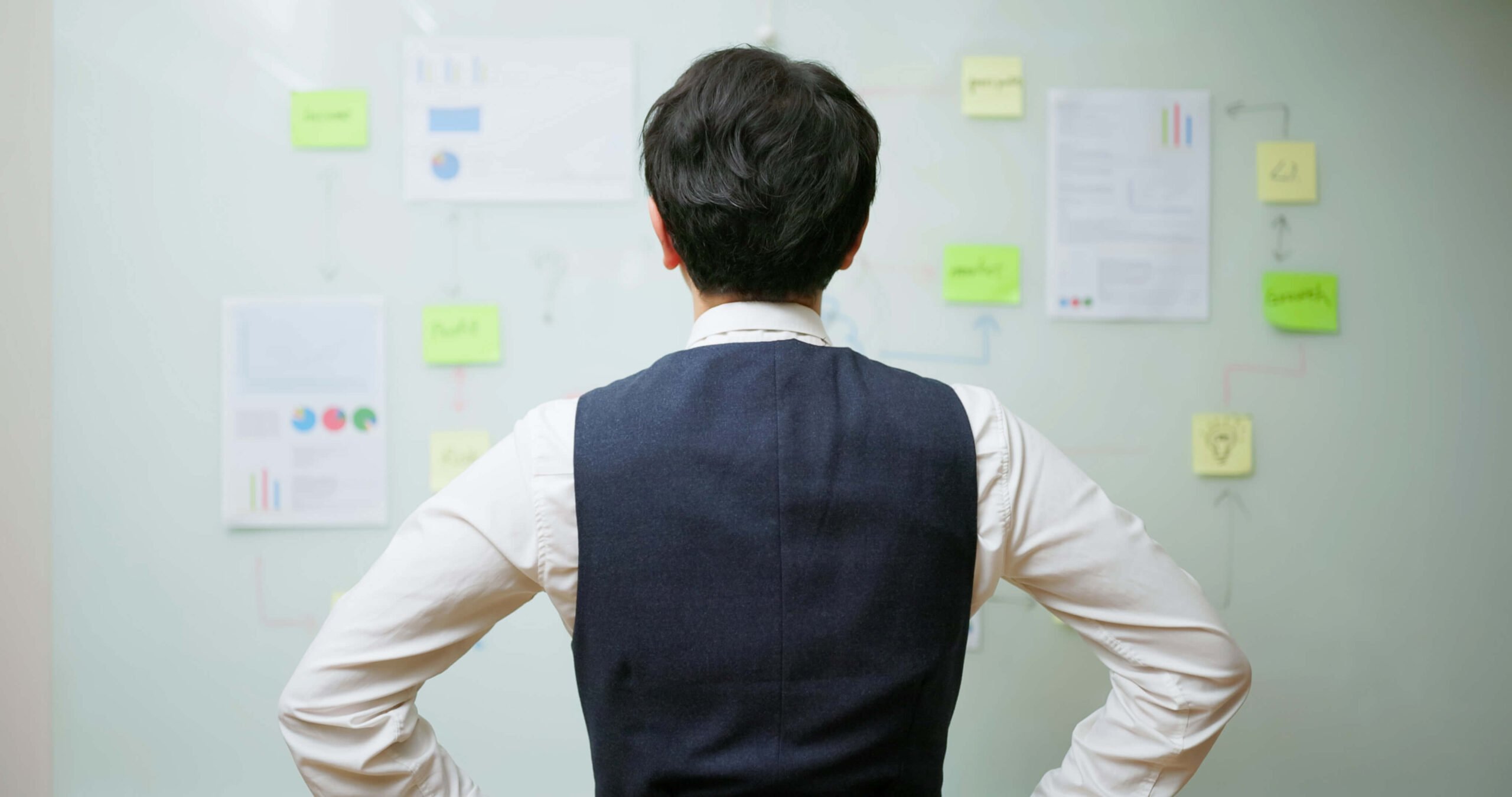 professional looking at board with workflow